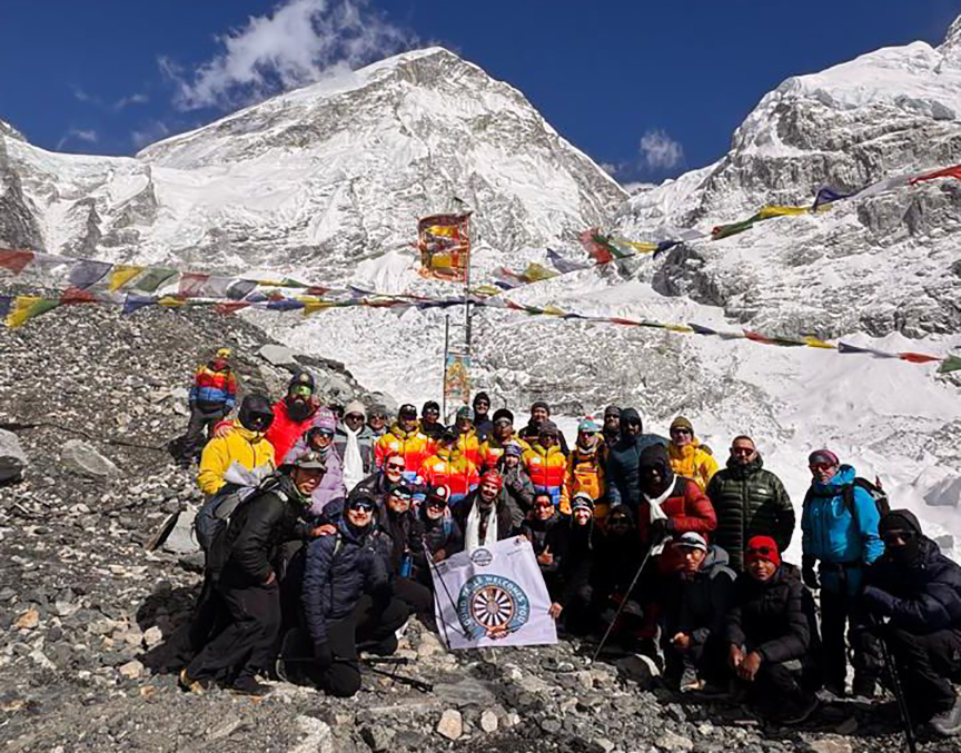 Icefall Doctors pose at Everest Base Camp with the Khumbu Icefall behind.
