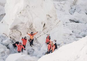 Sherpas wave hands in the Khumbu Icefall