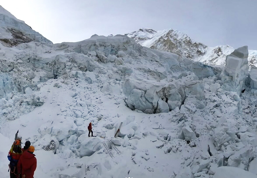 small figures below an icefall