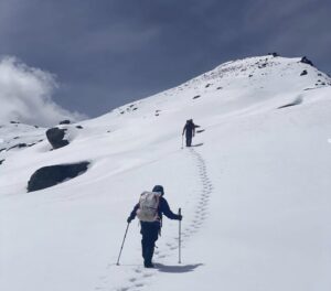 Climbers leaving their trails on a pristine snow slope.