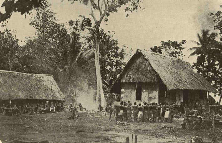 An old mission house and a crowd of people