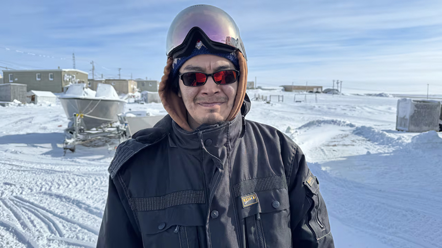 inuit man in snowmobile helmet