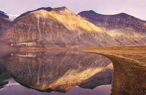 mountains mirrored in calm water