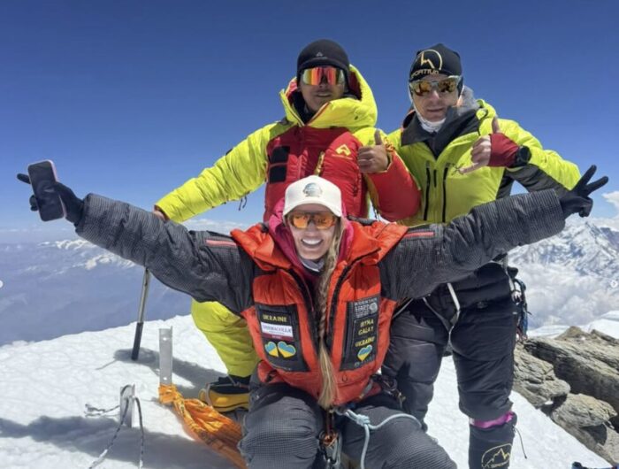Climbers cheer on a summit. 