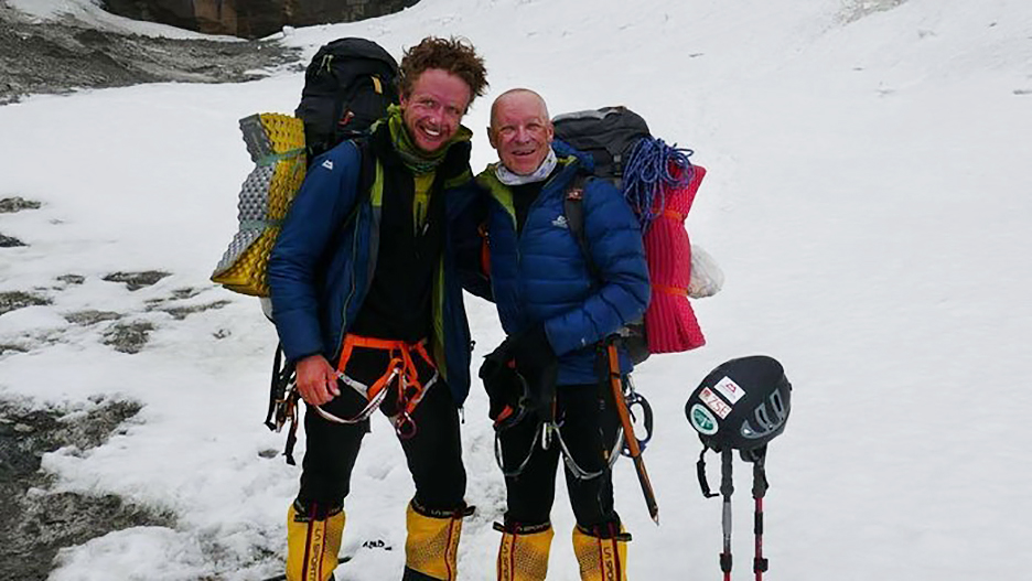 two climbers standing on snow