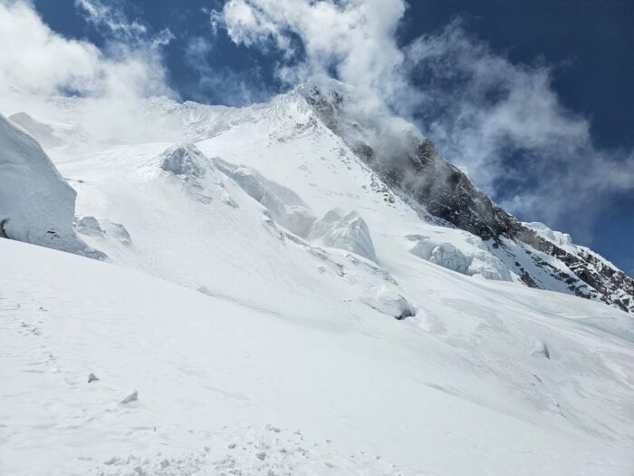 Manaslu with the summit wrapped in rags of clouds. 