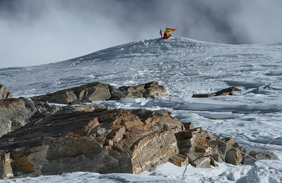 distant figure on mountain summit