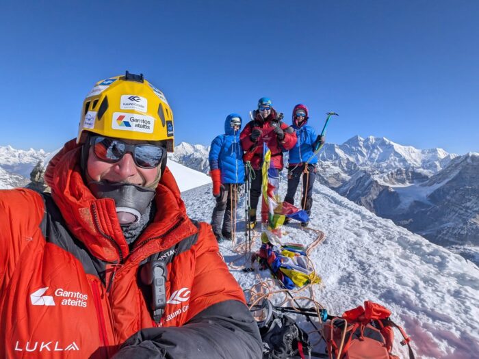Close shot of a climber with an air-trimming mask on the summit area of Mera Peak, Nepal. 