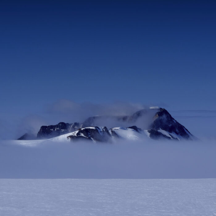 Newtontoppen, the highest mountain in Svalbard surrounded by light cloud