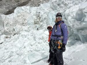 climbers with icefall background