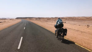cyclist on paved desert road