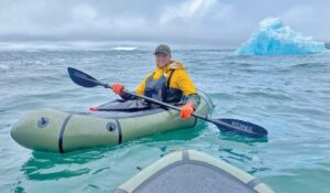 Adventurer paddling a packraft off the coast of Greenland