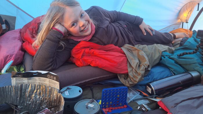 10 year old Norwegian adventurer Mina Read in a tent in Svalbard, Norway