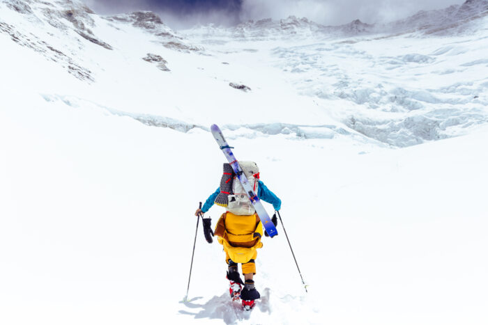 A climber heading towards Lhotse face with skis trapped to his backpack.