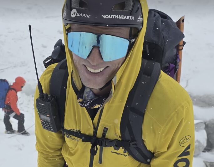 Close shot of Karl egloff if yellow jacket and sunglasses.