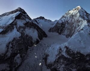 lights of headlamps on mountain at night