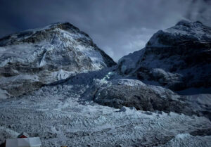 Khumbu icefall in the night with lights from the line of climbers.