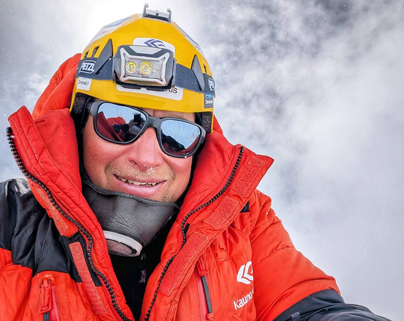 Close shot of Saulius Damulevicius with a helmet and an air-trimming mask under his chin.