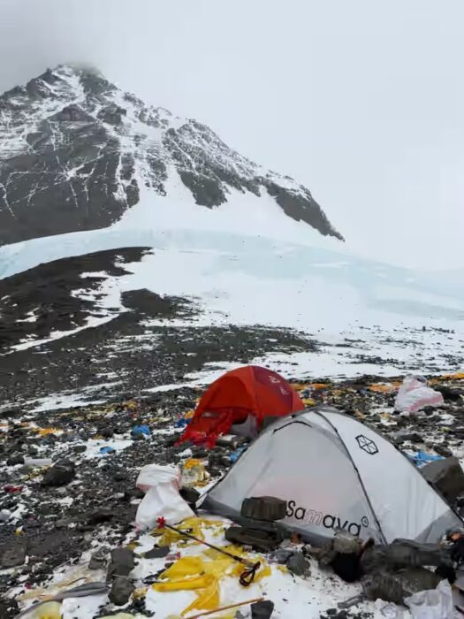 Tents and litter on the ground at Camp 4 on everest in a foggy day. 