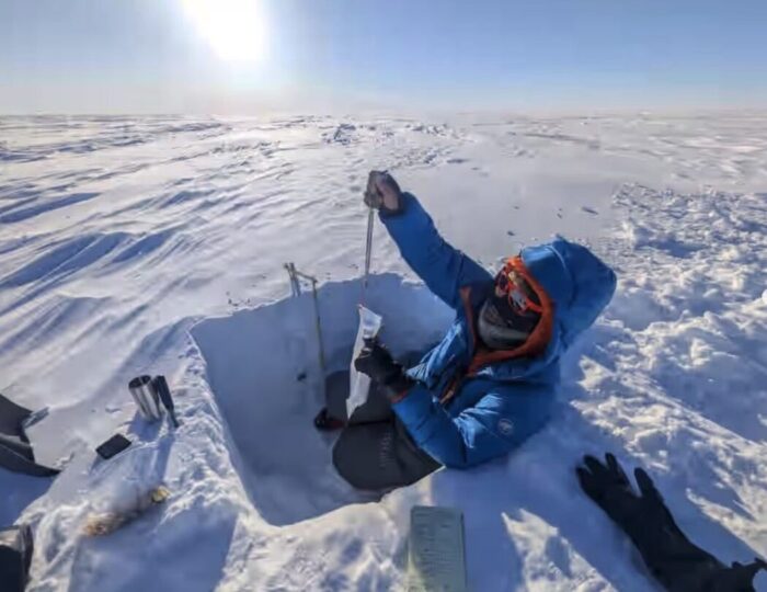 An adventurer taking snow samples on the Greenland Ice sheet