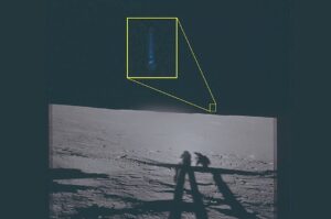 shadows of astronauts on moon with blue lights above them
