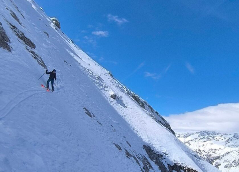 skier on steep mountainside