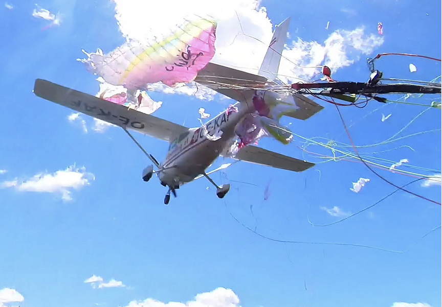 shredded paraglider on small airplane