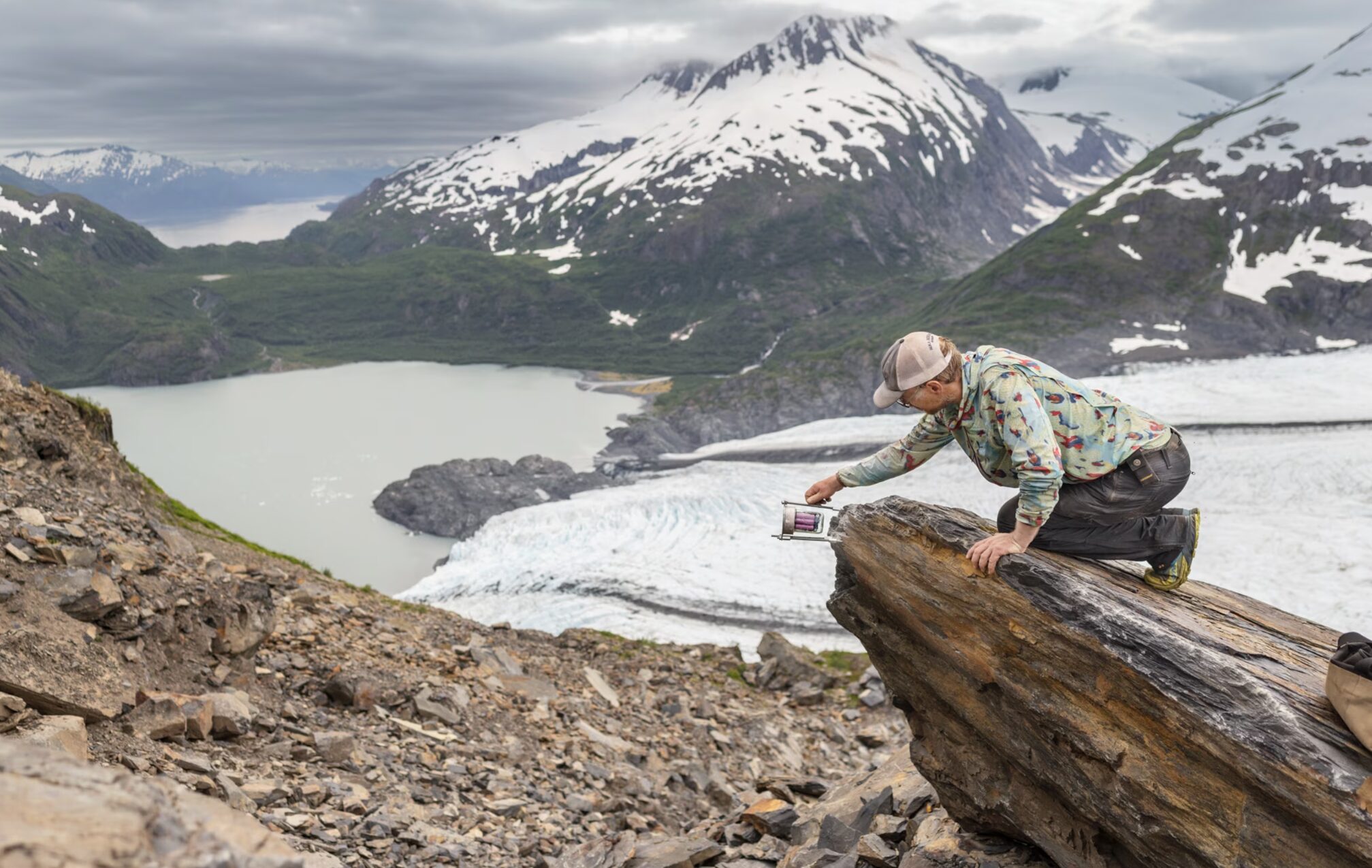 Higman attaches his monitoring equipment to a rock in the Portage Pass, Alaska