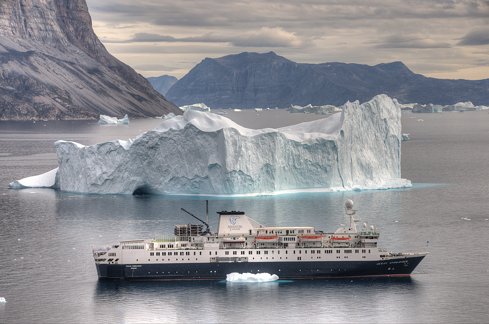 cruise ship, iceberg and greenland village
