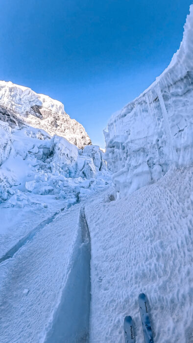 A pair of ski tips on the Khumbu Icefall, sliding parallel to a crevasse. 