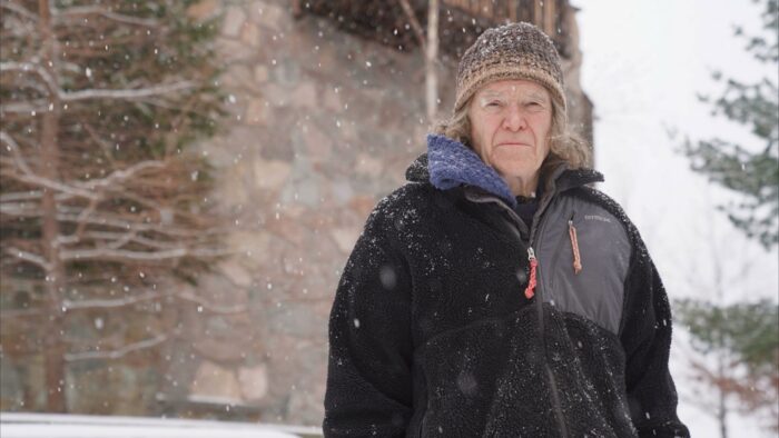 Veteran polar traveller Will Steger stands outside a building in snowy conditions