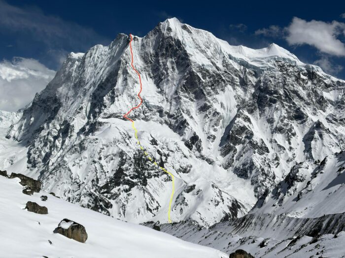 A route marked on the photo of a mountain. 