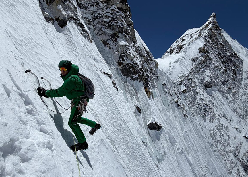 A climber on a steep snow ramp. 