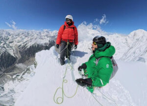 two climbers on a snowy mountaintop