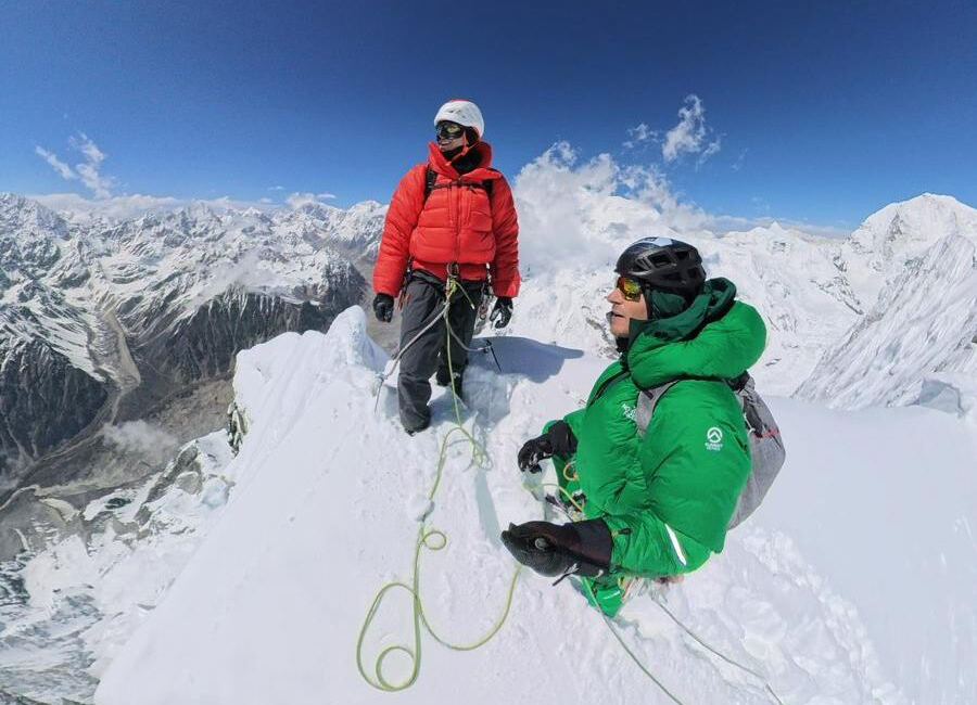 two climbers on a snowy mountaintop