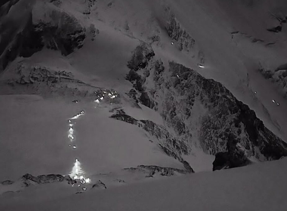 A line of lights (climbers' headlamps) in the night, across the Geneva Spur on Everest.