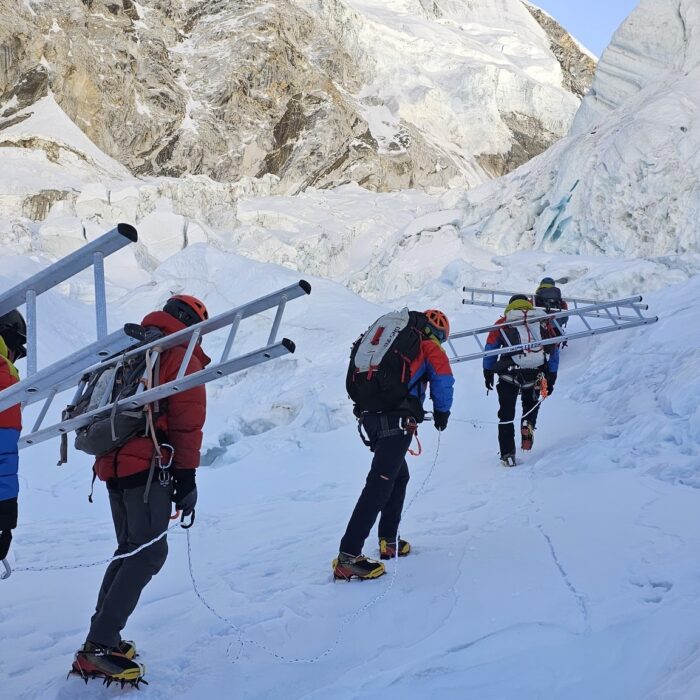 sherpas carrying ladders at the Khumbu Icefall on Everest