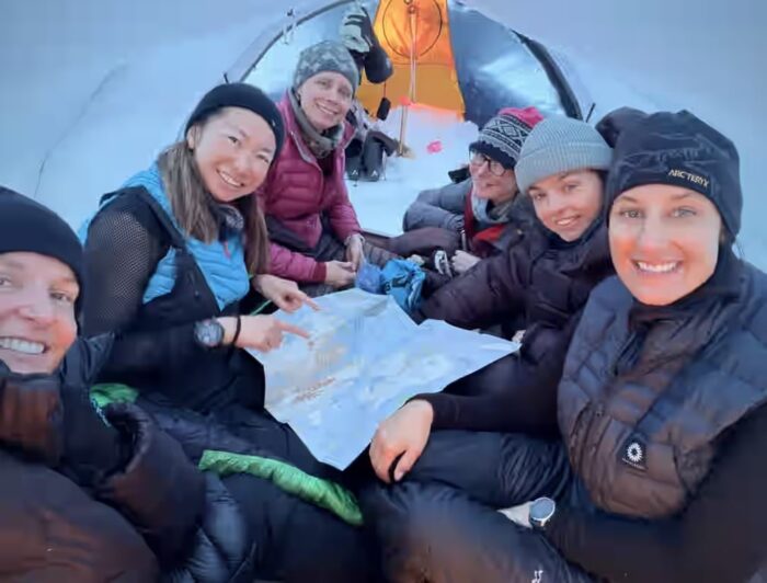 Six female adventurers known as "Girls Trip" sit in their tent in Svalbard, Norway