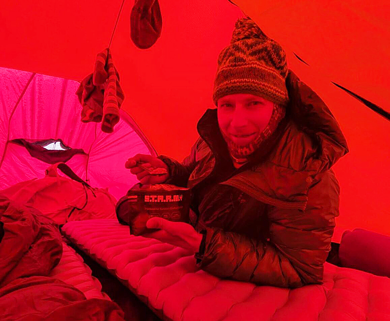 guy in very red tent, bathed in red light