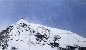 zoom image of some tiny figures of Sherpas on the summit ridge of Everest.