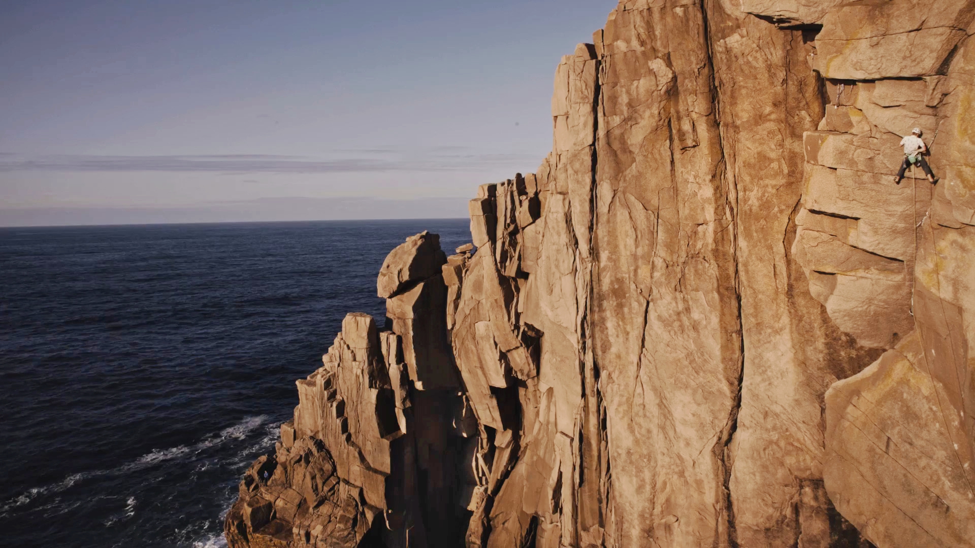 A man climbing a granite cliff