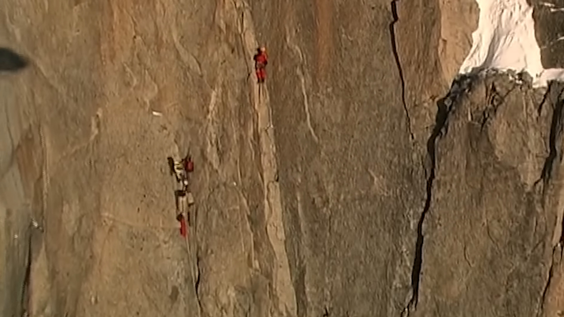 Two climbers on a rock wall