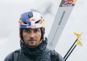 Close shot of Polish skier Andrzej bargiel with helmet and his skis on his backpack.