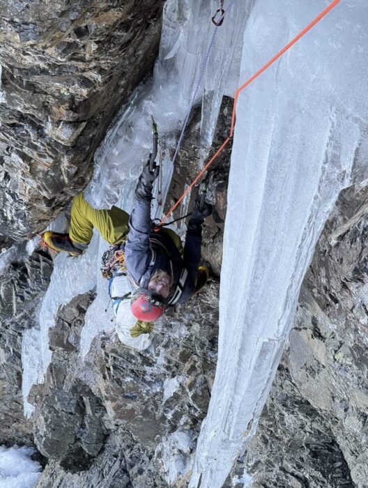 A climber on a dificult mixed route as seen from above.