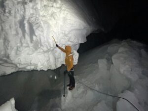 A climber among crevasses at Mont Blanc du Tacul in the night.