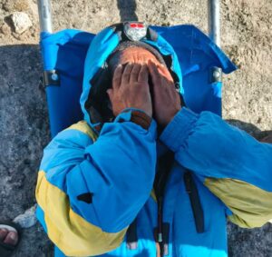 Hillary Dawa covers his face, finally down after six days.