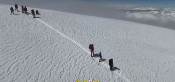 Frame of a video by Pablo Berlanga, showing Pemba walking on Chimborazo, accompained by his human companions. 