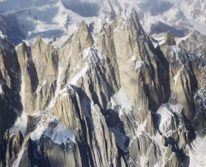 A group of rocky spires capped in snow.