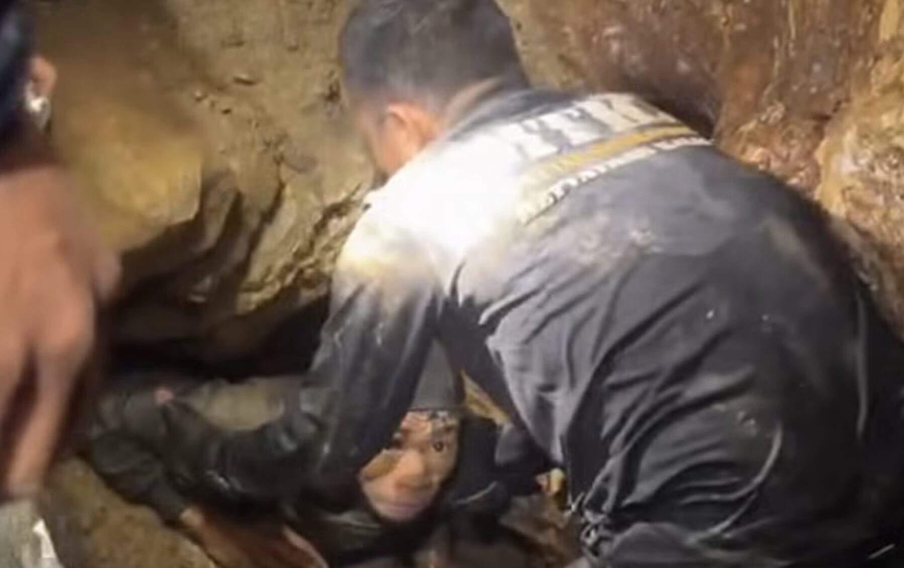A caver in a narrow passage.