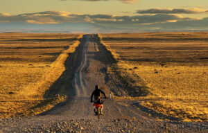 straight prairie trail with cyclist